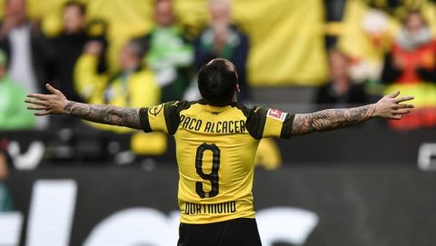 Dortmund's scorer Paco Alcacer celebrates after scoring during the German Bundesliga soccer match between Borussia Dortmund and VfL Wolfsburg in Dortmund, Germany, Saturday, March 30, 2019. (AP Photo/Martin Meissner)