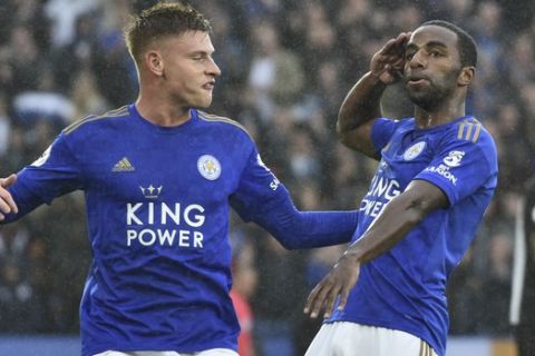 Leicester's Ricardo Pereira, right, celebrates after scoring the opening goal during the English Premier League soccer match between Leicester City and Newcastle United at the King Power Stadium in Leicester, England, Sunday, Sept. 29, 2019. (AP Photo/Rui Vieira)