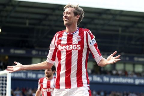 Stoke City's Peter Crouch celebrates scoring his side's first goal of the game against West Bromwich during their English Premier League soccer match at The Hawthorns, West Bromwich, England, Sunday Aug. 27, 2017. (Nick Potts/PA via AP)