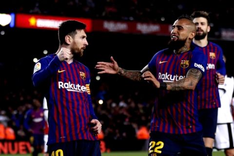 FC Barcelona's Lionel Messi, left, celebrates after scoring his side's second goal from a penalty spot during the Spanish La Liga soccer match between FC Barcelona and Rayo Vallecano at the Camp Nou stadium in Barcelona, Spain, Saturday, March 9, 2019. (AP Photo/Manu Fernandez)