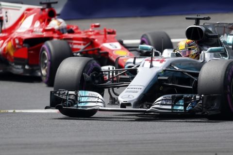 Mercedes driver Lewis Hamilton of Britain takes a curve followed by Ferrari driver Sebastian Vettel of Germany during the third practice session for the Austrian Formula One Grand Prix at the Red Bull Ring in Spielberg, Austria, Saturday, July 8, 2017. The Austrian Grand Prix will be held on Sunday. (AP Photo/Darko Bandic)