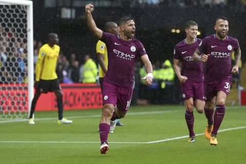 Manchester City's Sergio Aguero, centre, celebrates scoring his side's first goal against Watford during their English Premier League soccer match at Vicarage Road in Watford, England, Saturday Sept. 16, 2017. (Nigel French/PA via AP)