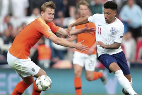 England's Jadon Sancho, right, duels for the ball with Netherlands' Matthijs de Ligt during the UEFA Nations League semifinal soccer match between Netherlands and England at the D. Afonso Henriques stadium in Guimaraes, Portugal, Thursday, June 6, 2019. (AP Photo/Luis Vieira)