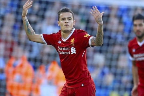 Liverpool's Philippe Coutinho celebrates scoring his side's first goal of the game during the Premier League soccer match. Leicester City versus Liverpool at the King Power Stadium, Leicester, England,  Saturday Sept. 23, 2017. (Mike Egerton/PA via AP)