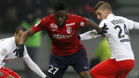 Lille's Divock Origi, center, controls the ball during their French League one soccer match against PSG at the Lille Metropole stadium, in Villeneuve d'Ascq, northern France, Wednesday, Dec. 3, 2014. (AP Photo/Michel Spingler)
