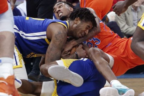 Golden State Warriors forward Marquese Chriss, front, and Oklahoma City Thunder guard Terrance Ferguson, rear, fight for the ball in the first half of an NBA basketball game Sunday, Oct. 27, 2019, in Oklahoma City. (AP Photo/Sue Ogrocki)