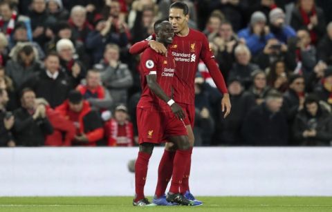 Liverpool's Sadio Mane, left, celebrates with his teammate Virgil van Dijk, his goal against Everton during the English Premier League soccer match between Liverpool and Everton at Anfield Stadium, Liverpool, England, Wednesday, Dec. 4, 2019. (AP Photo/Jon Super)