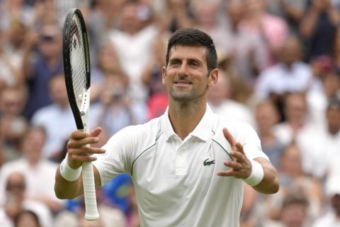 Serbia's Novak Djokovic celebrates after beating Korea's Kwon Soonwoo in a men's first round singles match on day one of the Wimbledon tennis championships in London, Monday, June 27, 2022. (AP Photo/Kirsty Wigglesworth)