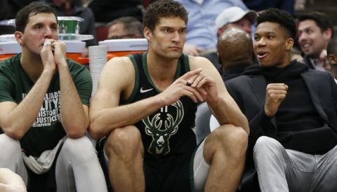 From left to right, Milwaukee Bucks forward Nikola Mirotic, center Brook Lopez, and forward Giannis Antetokounmpo sit on the bench late in the second half of an NBA basketball game against the Chicago Bulls, Monday, Feb. 25, 2019, in Chicago. (AP Photo/Nuccio DiNuzzo)