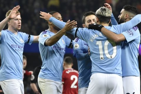 Manchester City players celebrate after Manchester City's Sergio Aguero, second right, scored his side's opening goal during the English Premier League soccer match between Manchester City and Sheffield United at Etihad stadium in Manchester, England, Sunday, Dec. 29, 2019. (AP Photo/Rui Vieira)