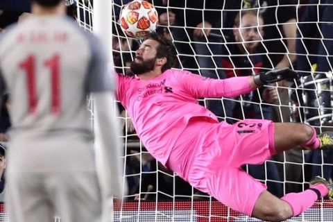 Liverpool goalkeeper Alisson fails to stop Barcelona's Lionel Messi's shot on goal, giving Barcelona a 3-0 lead during the Champions League semifinal first leg soccer match between FC Barcelona and Liverpool at the Camp Nou stadium in Barcelona, Spain, Wednesday, May 1, 2019. (AP Photo/Manu Fernandez)