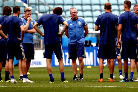 Sweden national soccer team players gather around head coach Janne Andersson, center, at the start of a training session on the eve of their Group F match against Germany, during the 2018 soccer World Cup in Sochi, Russia, Friday, June 22, 2018. (AP Photo/Rebecca Blackwell)