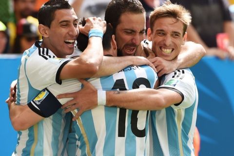 BRASILIA, BRAZIL - JULY 05:  Gonzalo Higuain of Argentina (2nd L) celebrates scoring his team's first goal with Angel di Maria (L), Lionel Messi (2nd L) and Lucas Biglia during the 2014 FIFA World Cup Brazil Quarter Final match between Argentina and Belgium at Estadio Nacional on July 5, 2014 in Brasilia, Brazil.  (Photo by Matthias Hangst/Getty Images)