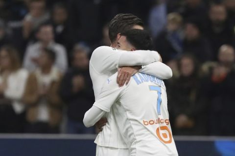 Marseille's Kevin Strootman, left, and Marseille's Nemanja Radonjic celebrate their victory after the French League One soccer match between Marseille and Brest at the Velodrome stadium in Marseille, southern France, Friday, Nov. 29, 2019. (AP Photo/Daniel Cole)