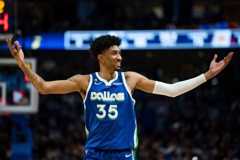 Dallas Mavericks forward Christian Wood (35) gestures to the crowd after scoring in the second half of an NBA basketball game against the Los Angeles Lakers in Dallas, Sunday, Dec. 25, 2022. (AP Photo/Emil T. Lippe)