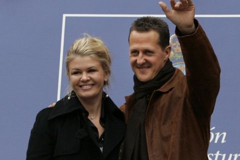 Former Formula One World champion Michael Schumacher and his wife Corina, wave at their arrival in Oviedo, northern Spain, Friday Oct. 26 2007 before the ceremony of the year's prestigious Prince of Asturias prizes. Schumacher will receive the 2007 Prince of Asturias Sport Award. (AP Photo/Bernat Armangue)