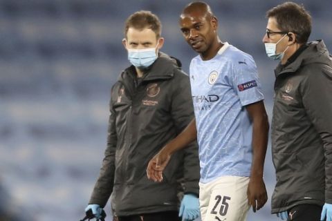 Manchester City's Fernandinho leaves the pitch after getting injured during the Champions League group C soccer match between Manchester City and FC Porto at the Etihad stadium in Manchester, England, Wednesday, Oct. 21, 2020. (Martin Rickett/Pool via AP)