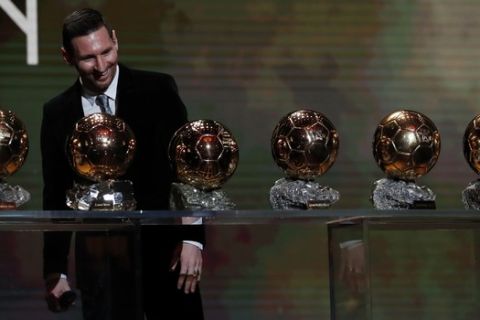 Barcelona's soccer player Lionel Messi looks his six golden balls during the Golden Ball award ceremony in Paris, Monday, Dec. 2, 2019. (AP Photo/Francois Mori)