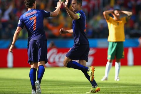 PORTO ALEGRE, BRAZIL - JUNE 18:  Robin van Persie of the Netherlands celebrates with Daryl Janmaat after scoring the second goal during the 2014 FIFA World Cup Brazil Group B match between Australia and Netherlands at Estadio Beira-Rio on June 18, 2014 in Porto Alegre, Brazil.  (Photo by Dean Mouhtaropoulos/Getty Images)