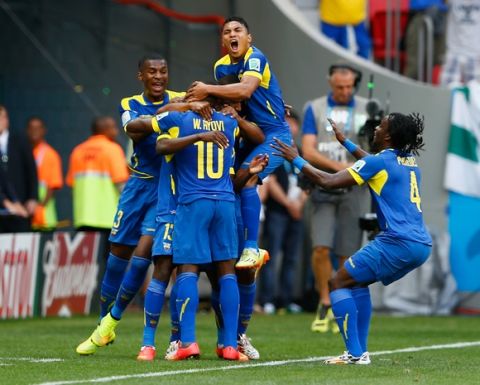 BRASILIA, BRAZIL - JUNE 15:  Enner Valencia of Ecuador (hidden) celebrates scoring his team's first goal with his teammates during the 2014 FIFA World Cup Brazil Group E match between Switzerland and Ecuador at Estadio Nacional on June 15, 2014 in Brasilia, Brazil.  (Photo by Matthew Lewis/Getty Images)