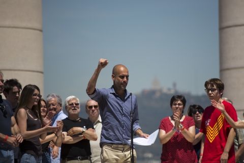 Manchester City coach Pep Guardiola gestures after delivering a speech during a protest organised by the National Assembly for Catalonia, to support the call for referendum in Barcelona, Spain, Sunday, June 11, 2017. On Friday, Catalonia's regional president Carles Puigdemont announced that his government would hold the independence referendum on Oct. 1. Spain's government has promised to not allow the vote on grounds that is unconstitutional since it is matter that would affect all Spaniards. (AP Photo/Emilio Morenatti)
