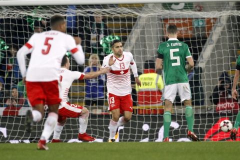 Switzerland's Ricardo Rodriguez, center, celebrates after scoring the opening goal from the penalty spot during the World Cup qualifying play-off first leg soccer match between Northern Ireland and Switzerland at Windsor Park in Belfast, Northern Ireland, Thursday Nov. 9, 2017. (AP Photo/Peter Morrison)