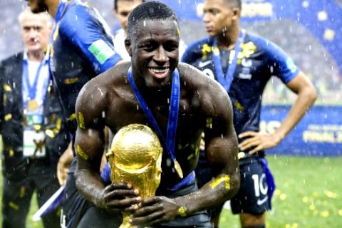 France's Benjamin Mendy holds the trophy at the end of the final match between France and Croatia at the 2018 soccer World Cup in the Luzhniki Stadium in Moscow, Russia, Sunday, July 15, 2018. (AP Photo/Matthias Schrader)