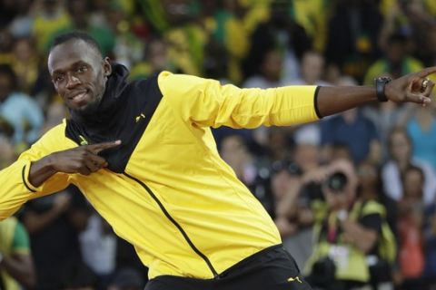 Jamaica's Usain Bolt makes his trademark gesture during a lap of honor at the end of the World Athletics Championships in London Sunday, Aug. 13, 2017. (AP Photo/Matthias Schrader)
