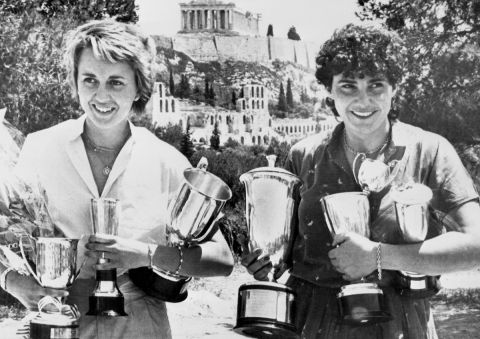 Michele Mouton, of France, right, holding her winner's Cups for winning the 29th Acropolis Motor Rally in an Audi Quattro, poses here on June 4, 1982 with the Acropolis in the background and co-driver Fabrizia Pons of Italy. She was the first female driver to ever win the grueling four day event. (AP Photo/Saris)