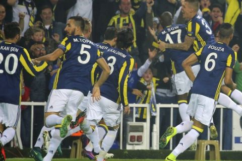 Fenerbahce players celebrate with their teammate Moussa Sow, centre no 17, after he scored against Manchester United, during a Europa League group A soccer match between Fenerbahce and Manchester United, in Istanbul, Thursday, Nov. 3, 2016. (AP Photo)