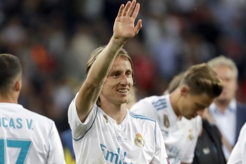 Real Madrid's Luka Modric celebrates after winning the Champions League Final soccer match between Real Madrid and Liverpool at the Olimpiyskiy Stadium in Kiev, Ukraine, Saturday, May 26, 2018. (AP Photo/Sergei Grits)