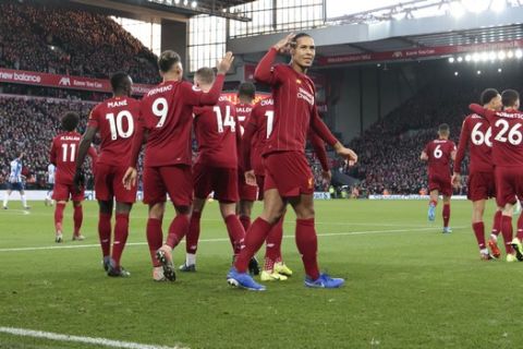Liverpool's Virgil van Dijk centre right celebrates after scoring his second goal during the English Premier League soccer match between Liverpool and Brighton at Anfield Stadium, Liverpool, England, Saturday, Nov. 30, 2019. (AP Photo/Jon Super)