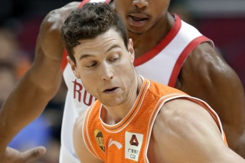 Shanghai Sharks guard Jimmer Fredette (32) looks to drive around Houston Rockets forward Bruno Caboclo (5) during the second half of an exhibition NBA basketball game Tuesday, Oct. 9, 2018, in Houston. (AP Photo/Michael Wyke)