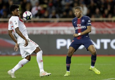 PSG's Kylian Mbappe, right, battles for the ball with Monaco's Jesus Nascimento Jemerson during the French League One soccer match between AS Monaco and Paris Saint-Germain at Stade Louis II in Monaco, Sunday, Nov. 11, 2018 (AP Photo/Claude Paris)