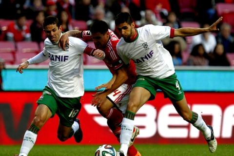 Benfica's Maxi Pereira, center, from Uruguay, battles for the ball with Maritimo's Igor Rossi, right, from Brazil, and Luis Olim during the Portuguese league soccer match between Benfica and Maritimo at Benfica's Luz stadium in Lisbon, Sunday, Jan. 19, 2014. Benfica won 2-0. (AP Photo/Francisco Seco)