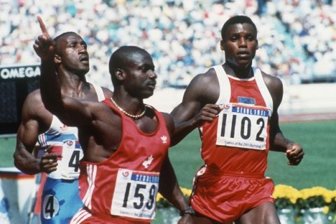 Canadian Ben Johnson, left, signals victory as he wins the 100-meter final for the gold medal in the Seoul Olympics Sept. 25, 1988. At right is American Carl Lewis who finished second. (AP Photo/Rick Wilking)