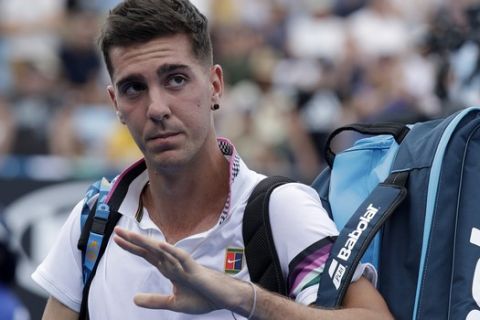 Australia's Thanasi Kokkinakis waves after he retired injured from his first round match against Japan's Taro Daniel at the Australian Open tennis championships in Melbourne, Australia, Tuesday, Jan. 15, 2019. (AP Photo/Kin Cheung)