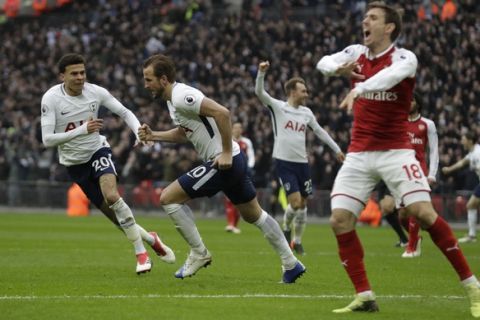 Tottenham Hotspur's Harry Kane centre, celebrates with teammate Tottenham Hotspur's Dele Alli, left, after he scored the opening goal of the game during the English Premier League soccer match between Tottenham Hotspur and Arsenal at Wembley stadium in London, Saturday, Feb. 10, 2018. (AP Photo/Matt Dunham)