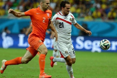 SALVADOR, BRAZIL - JULY 5:  Netherlands' Ron Vlaar (2) vies for the ball with Costa Rica's Marcos Urena (21) during the 2014 FIFA World Cup quarter final soccer match between the Netherlands and Costa Rica at the Arena Fonte Nova in Salvador, Brazil, on July 5, 2014. (Photo by Ibrahim Yakut/Anadolu Agency/Getty Images)