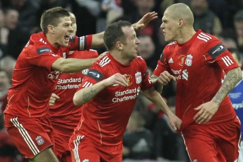Liverpool's Martin Skrtel, right, celebrates his goal against Cardiff City with teammates Steven Gerrard, left, and Charlie Adam during their English League Cup final soccer match at Wembley Stadium, London, Sunday, Feb. 26, 2012. (AP Photo/Sang Tan)