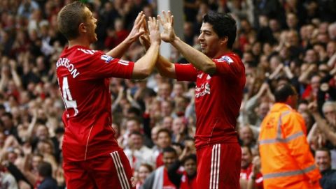 Liverpool's Luis Suarez, right, is celebrates with teammate Jordan Henderson after scoring against Wolverhampton Wanderers during their English Premier League soccer match at Anfield, Liverpool, England, Saturday Sept. 24, 2011. (AP Photo/Tim Hales)