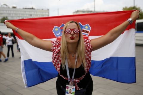 A Croatia fan poses for a picture as she arrives outside Luzhniki Stadium ahead of the final match between France and Croatia at the 2018 soccer World Cup, in Moscow, Russia, Sunday, July 15, 2018. (AP Photo/Rebecca Blackwell)