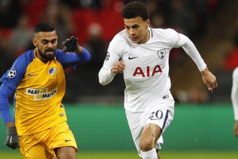 Tottenham's Dele Alli, right, fights for the ball with APOEL Nicosia's Ghayas Zahid during the Champions League Group H soccer match between Tottenham and APOEL Nicosia in London, Wednesday, Dec. 6, 2017. (AP Photo/Frank Augstein)