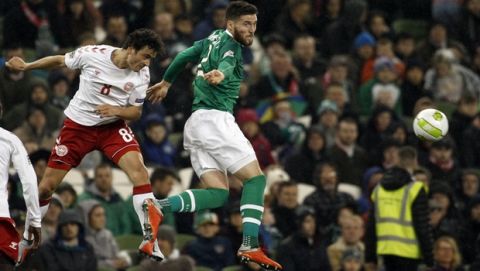 Denmark's Thomas Delaney, left, jumps for the ball with Ireland's Matthew Doherty during the UEFA Nations League soccer match between Ireland and Denmark at the Aviva Stadium in Dublin, Ireland, Saturday Oct. 13, 2018. (AP Photo/Peter Morrison)
