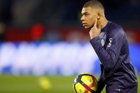 PSG's Kylian Mbappe warms up ahead of the French League One soccer match between Paris-Saint-Germain and Strasbourg at the Parc des Princes stadium in Paris, France, Sunday, April 7, 2019. (AP Photo/Francois Mori)