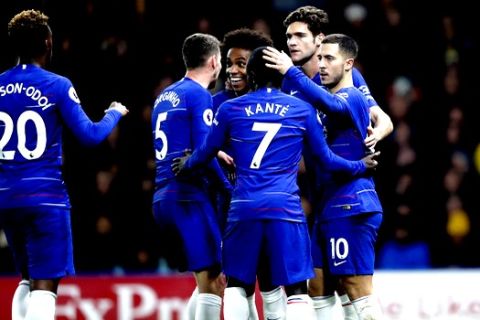 Chelsea's Eden Hazard, right, is congratulated by his team mates after scoring form penalty his side second goal during the English Premier League soccer match between Watford and Chelsea at Vicarage Road stadium in Watford, England on Wednesday, Dec. 26, 2018. (AP Photo/Frank Augstein)