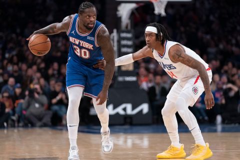 New York Knicks forward Julius Randle (30) looks to pass against Los Angeles Clippers guard Terance Mann (14) during the first half of an NBA basketball game, Sunday, Jan. 23, 2022, in New York. (AP Photo/John Minchillo)
