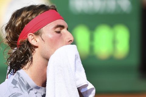 Greece's Stefanos Tsitsipas wipes his face during his match with Italy's Jannik Sinner, at the Italian Open tennis tournament in Rome, Wednesday, Sept. 16, 2020. (Alfredo Falcone/LaPresse via AP)