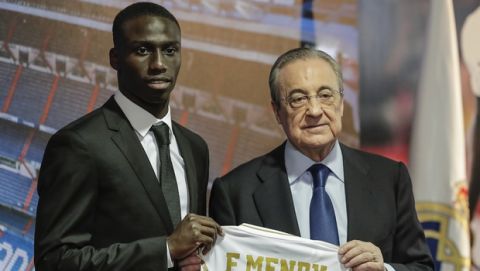 French soccer player Ferland Mendy, left, poses with Real Madrid president Florentino Perez during his official presentation after signing for Real Madrid at the Santiago Bernabeu stadium in Madrid, Spain, Wednesday, June 19, 2019. (AP Photo/Manu Fernandez)