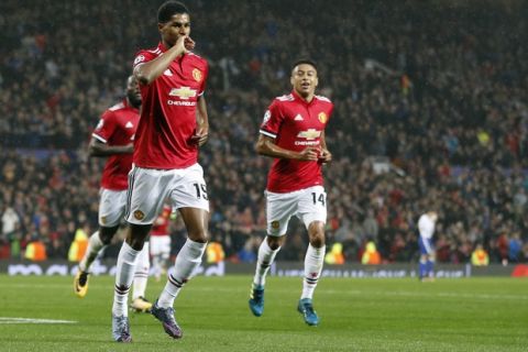 Manchester United's Marcus Rashford, left, celebrates his goal during the Champions League group A soccer match between Manchester United and Basel, at the Old Trafford stadium in Manchester, Tuesday, Sept. 12, 2017. (AP Photo/Frank Augstein)